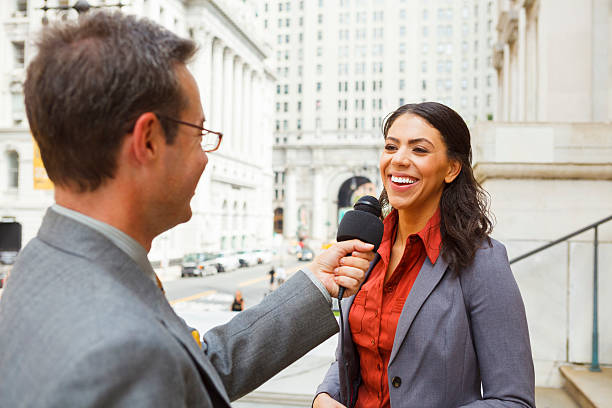 Man Interviews Smiling Woman stock photo
