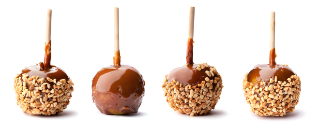 Four apples coated with caramel and three with nuts also.