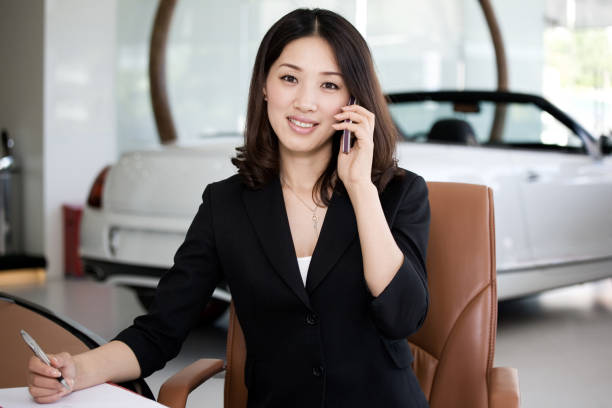 istock Car Salesperson on cell phone 155441144