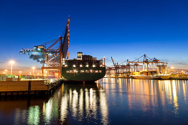 Hamburg Harbour, Cargo Terminal Hamburg Cargo terminal on a blue evening. bunt stock pictures, royalty-free photos & images