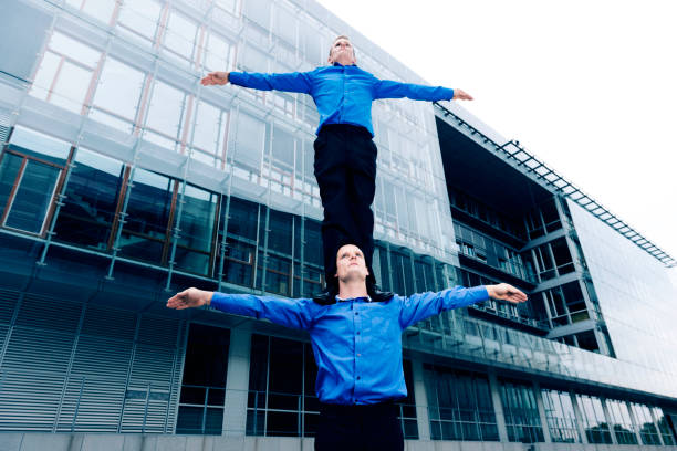 istock One businessman stands on the shoulder of another 155441350