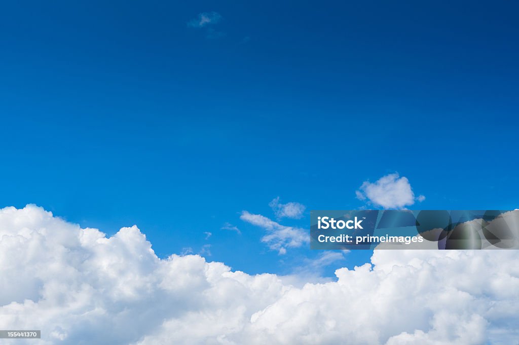 Blue sky with dramatic white clouds below Dramatic Cloudy Sky . Cloud - Sky Stock Photo