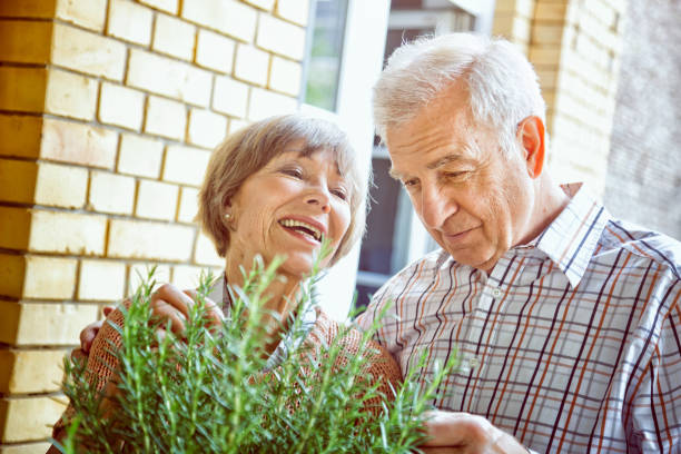 Senior couple enjoying home herb garden