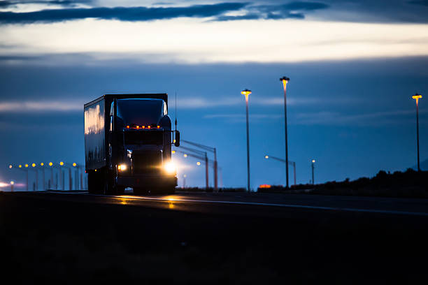Trucking Industry Semi Truck on highway at night commercial land vehicle photos stock pictures, royalty-free photos & images