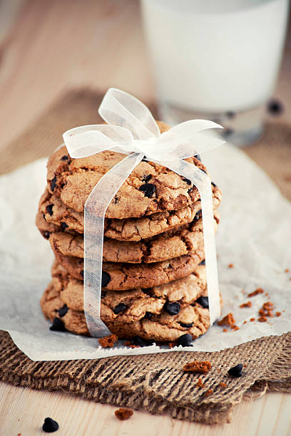 Seven chocolate chip cookies on a white and blue plate