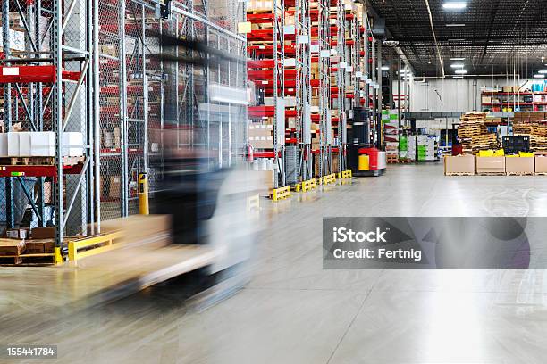 Moving Forklift In A Warehouse Stock Photo - Download Image Now - Warehouse, Forklift, Motion