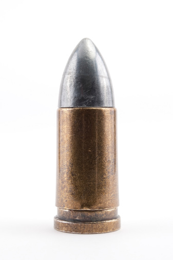 Large caliber 9mm bullet with a white background.