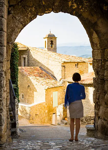 Woman admiring Lacoste old town (Provence, France).