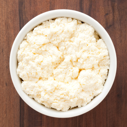 Top view of white bowl full of  ricotta cheese