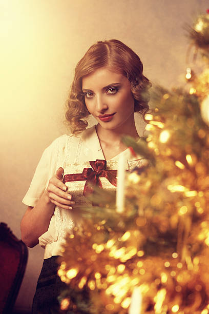 istock retro girl holding christmas gift 155442108