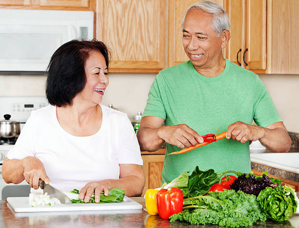 istock Mature Asian Couple Preparing Meals in the Kitchen 155442309