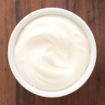 Top view of white bowl full of whipped cream