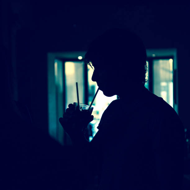 Silhouette of boy who is drinking