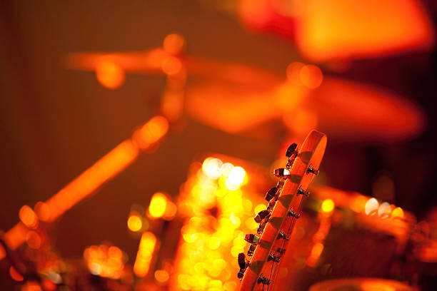 Guitar player on stage Part of a guitar player, available light , high iso shot, shallow depth of field! bunt stock pictures, royalty-free photos & images