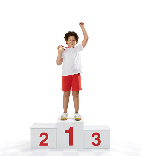Rewarding of the winner Child athlete enjoying victory on a winners podium. winners podium photos stock pictures, royalty-free photos & images