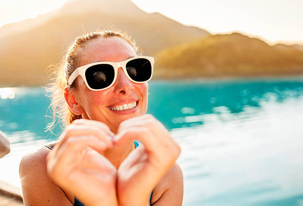 istock Woman and heart shaped fingers 155443474