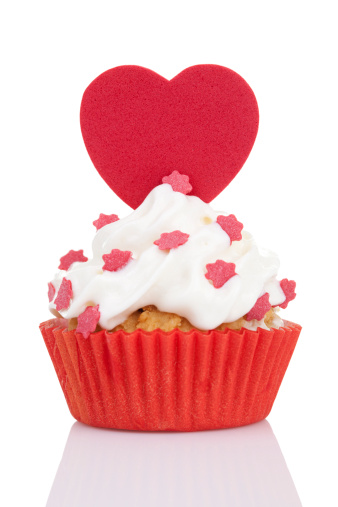 Two of heart shaped red and white cookies in half attach on white background