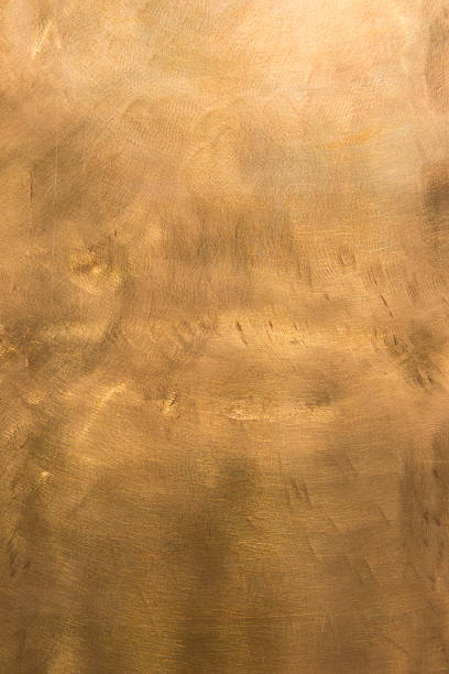Abstract copper surface textured and mottled background XXXL Brushed brown-golden copper or bronze surface, with visible brush strokes. The sheet metal has an appealing cloudy, wavy texture. Vertical orientation. The image has been shot outdoors during natural day light, full frame and close up. Ideal for backgrounds. The size of the photo is 4912 x 7360 px. High resolution. bronze colored stock pictures, royalty-free photos & images