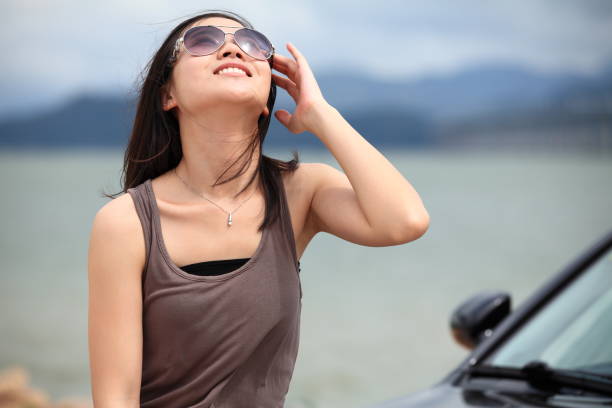 istock Style Asian woman at beach, with her ​​car, 155443628