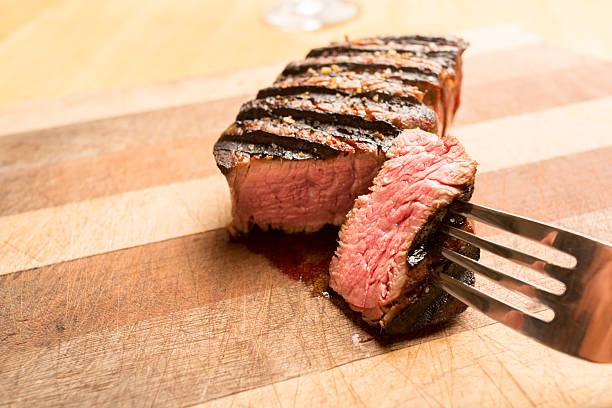 istock Grilled Beef Filet Mignon on a Wooden Cutting Board 155444009