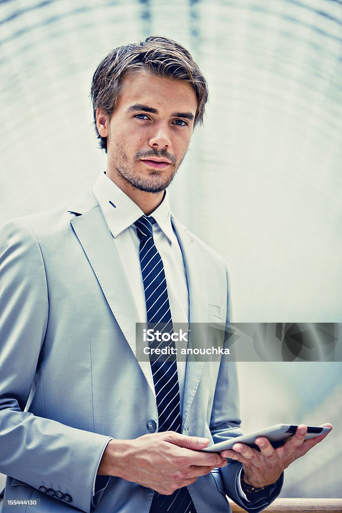 Handsome Young Businessman Using Digital tablet 25-29 Years Stock Photo