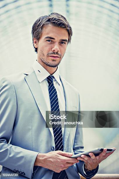 Handsome Young Businessman Using Digital Tablet Stock Photo - Download Image Now - 25-29 Years, Adult, Adults Only