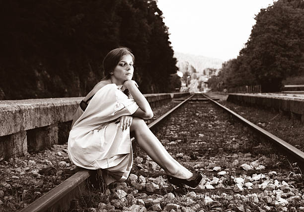 istock Attractive long haired brunette at railway station 155444179