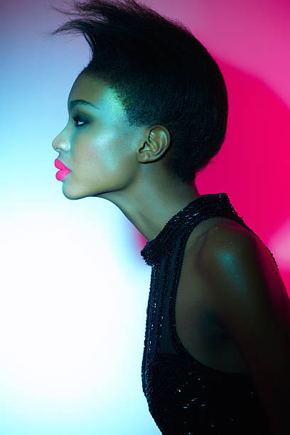 istock Side profile image of a model standing in neon lights 155444303
