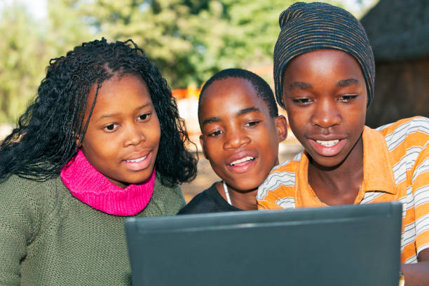 istock African children looking at Laptop 155444542