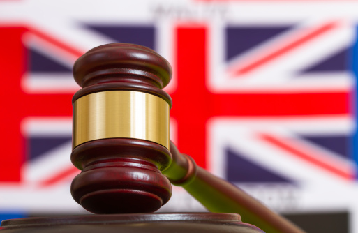 Gavel with flag of United Kingdom in the background. (Brexit)