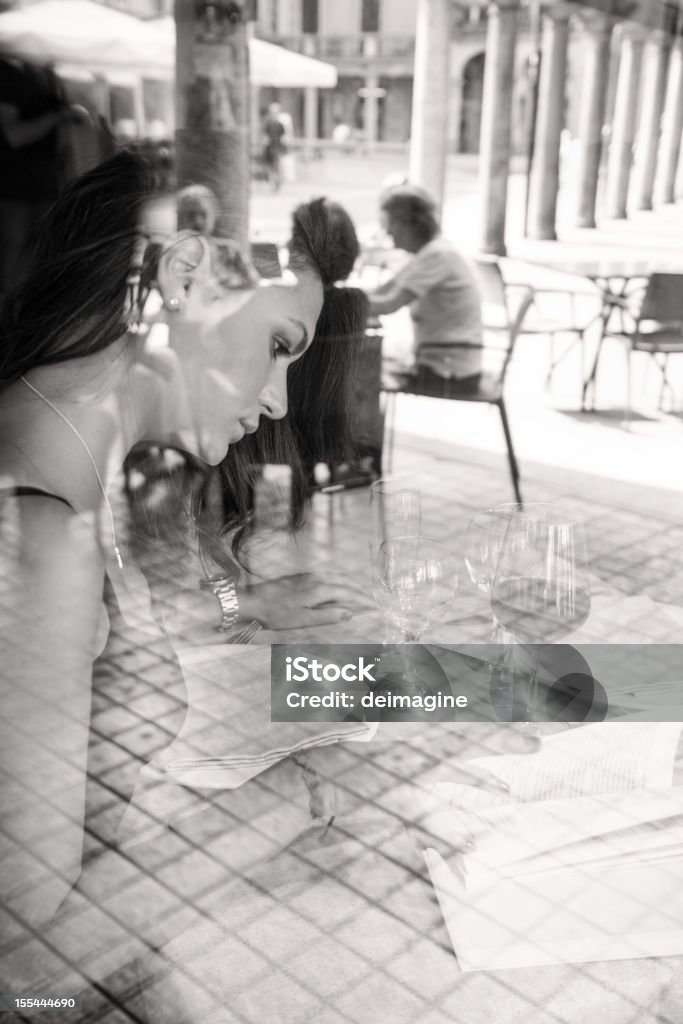 Woman in a restaurant Portrait of a  woman through window Black And White Stock Photo