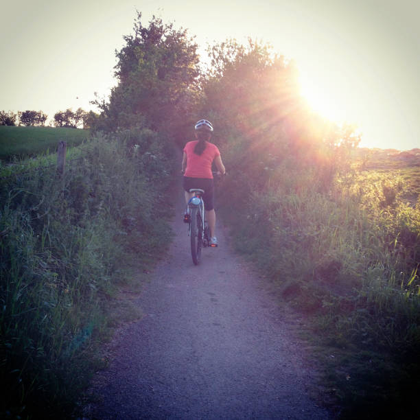 istock Women riding bicycle in the countryside 155444701