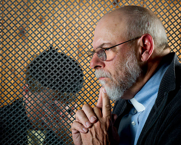 istock A patron giving a confession through a grate 155445186