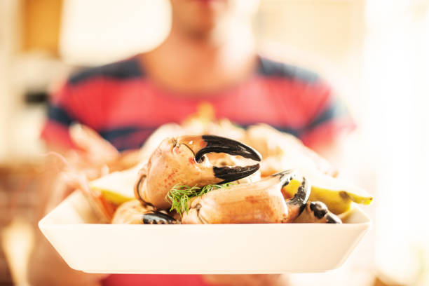 istock Man holding a tray of crab claws 155445407