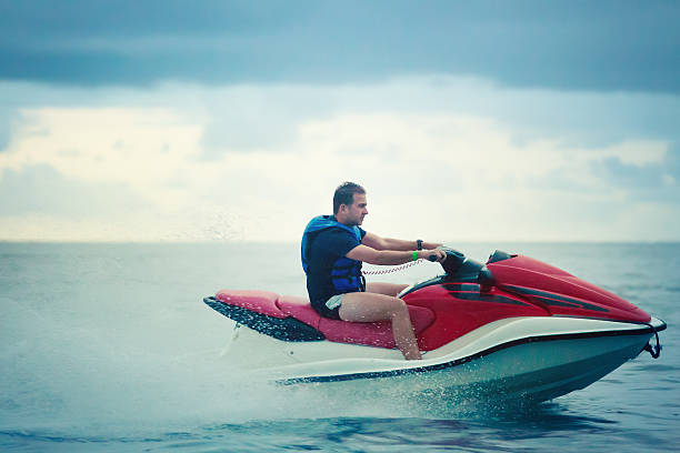 istock man ridding a jet ski 155445433