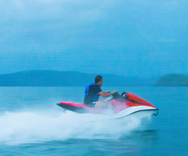 istock man ridding a jet ski 155445537