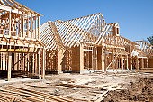 New homes construction site. Framed houses. Lumber. Building.