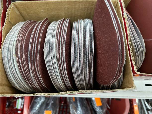 istock The stack of brown sandpaper sheet isolated on brown box background 1554457459