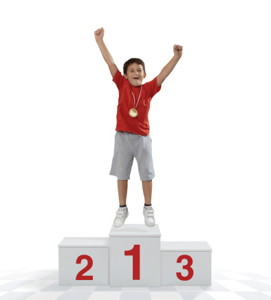 Child athlete enjoying victory on a winners podium.