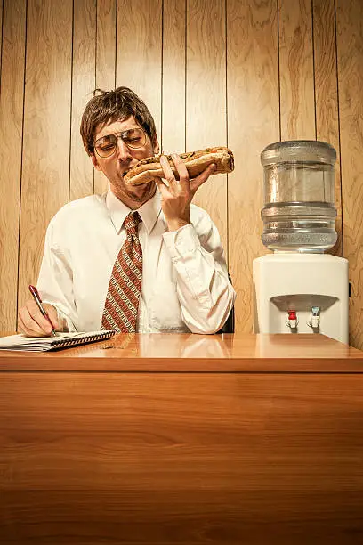 Photo of Business Man in Office With Sandwich