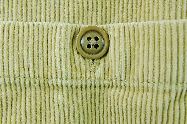 Close-up of a shirt pocket showing a button and button hole.