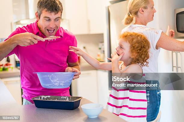 Real Family Of Three Making Cake In The Kitchen Stock Photo - Download Image Now - 30-34 Years, 35-39 Years, 4-5 Years