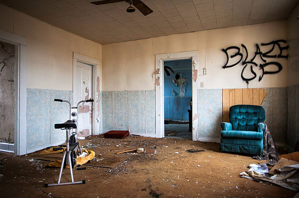 The interior of an abandoned home which includes a recliner chair and \