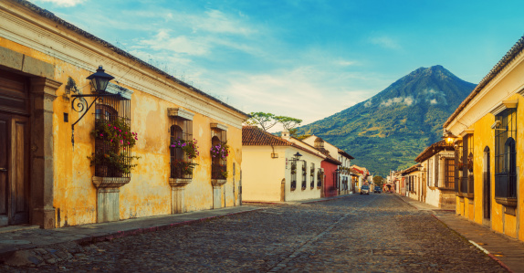 Cobblestone street in Antigua, Guatemala - Acatenango volcano in the back