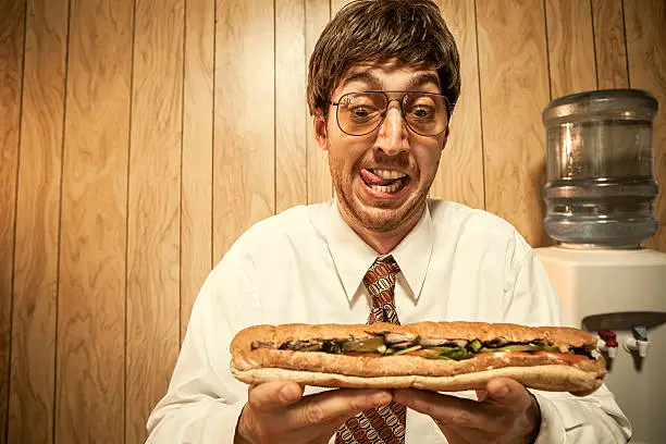Photo of Business Man in Office With Sandwich