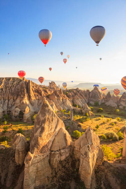 Hot air balloons over Love Valley, Cappadocia, Turkeys Hot air ballons over Love Valley near Goreme and Nevsehir in the center of Cappadocia, Turkey (region of Anatolia). This shot taken shortly after sunrise. rock hoodoo stock pictures, royalty-free photos & images