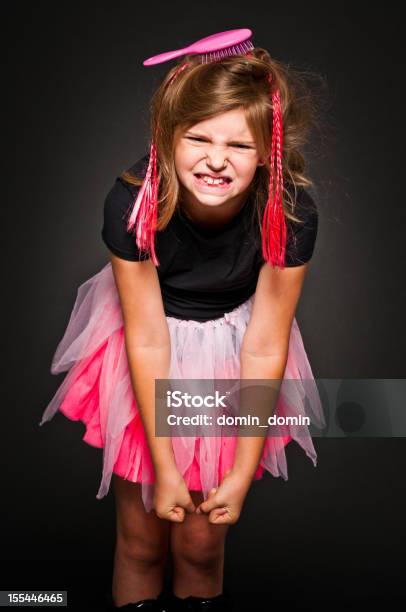 Young Angry Rude Girl With Hair Brush And Artificial Braids Stock Photo - Download Image Now