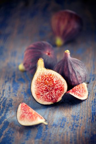 Sliced ripe figs on a wooden table
