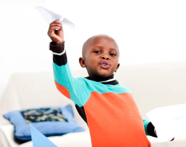 istock Little boy playing with paper airplane 155446729