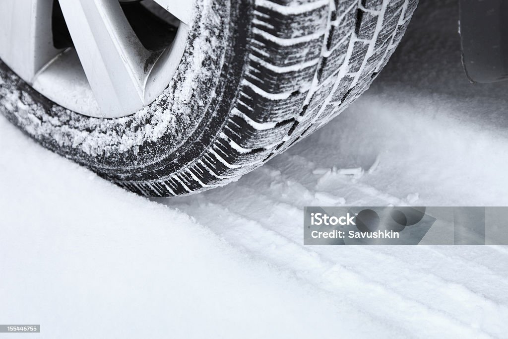 Winter tire Winter tire in the snow. Tire - Vehicle Part Stock Photo